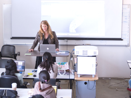 instructor presenting in class using a digital projector.
